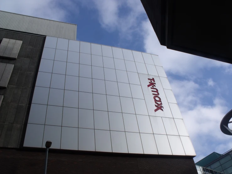 a white building with a red sign on it