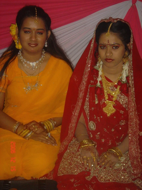 two women in brightly colored sars sitting next to each other