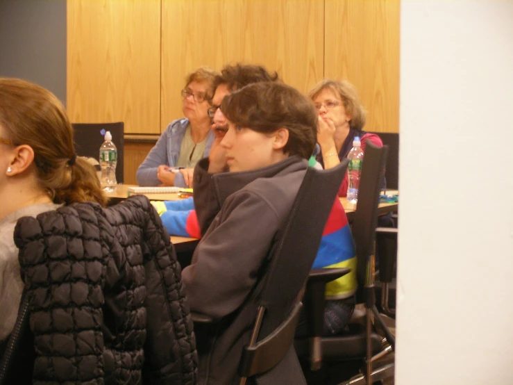 the audience watches the woman talking at the table