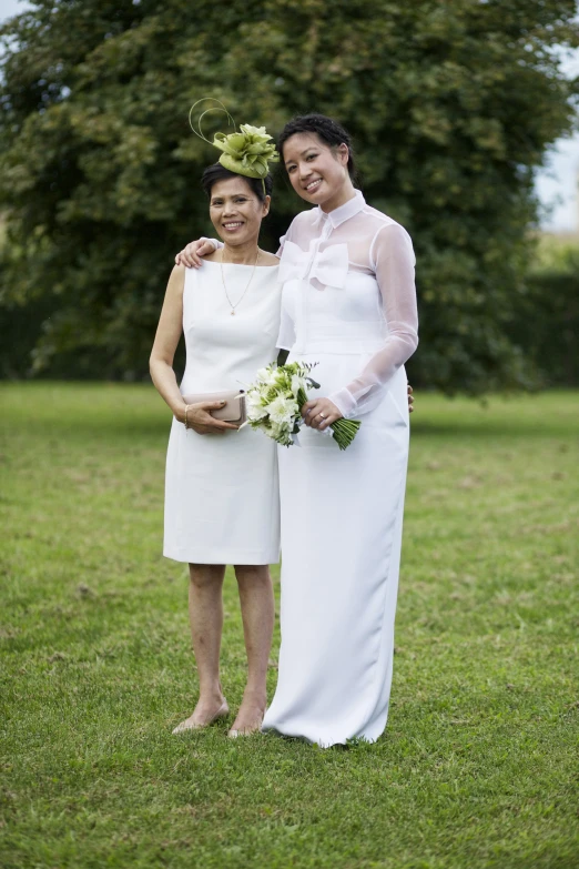 two brides are posing for a picture together