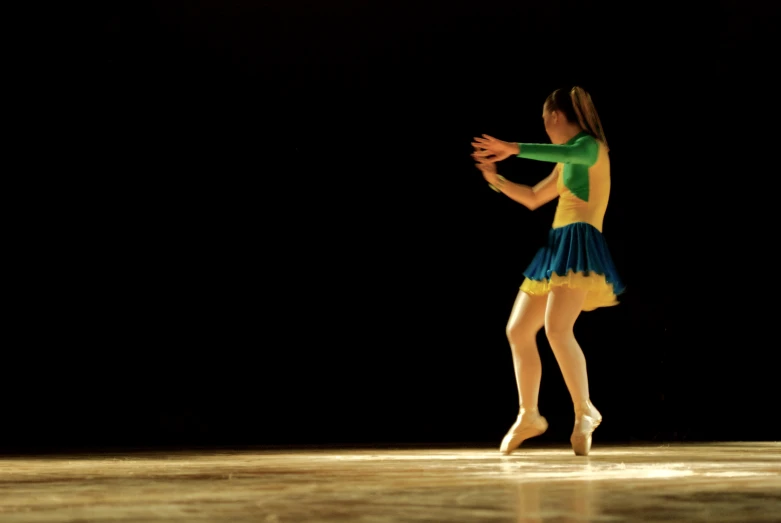 a woman in a colorful costume standing in the middle of a floor