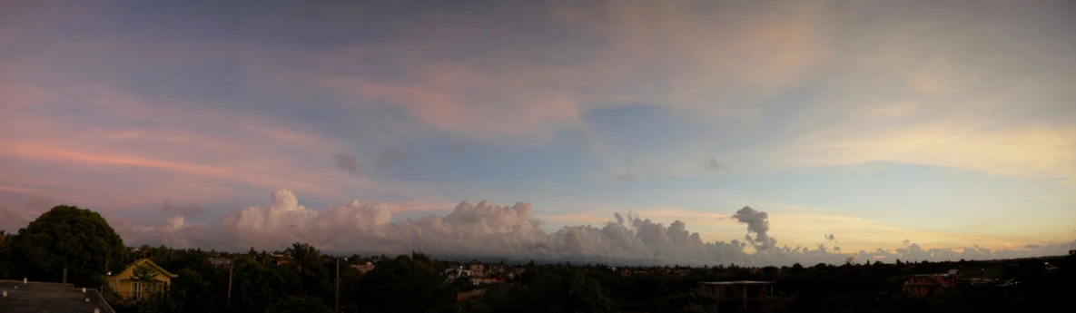 a sunset view of a city from a hill