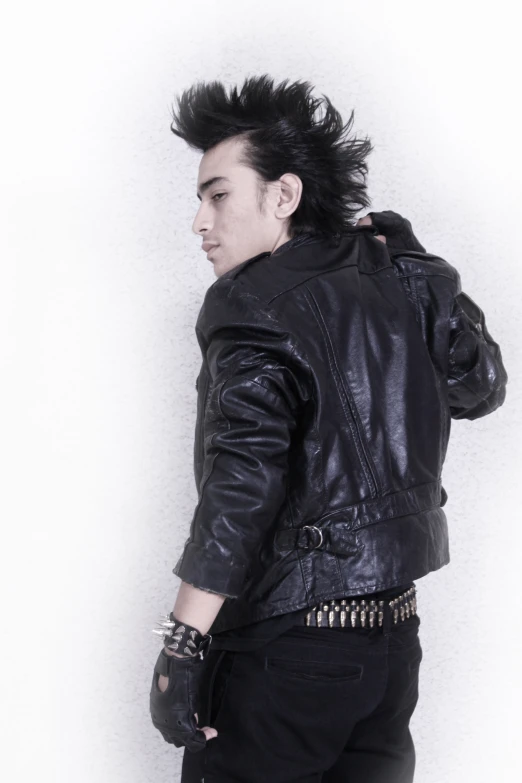 a person in a black leather jacket and celets is posing for a po