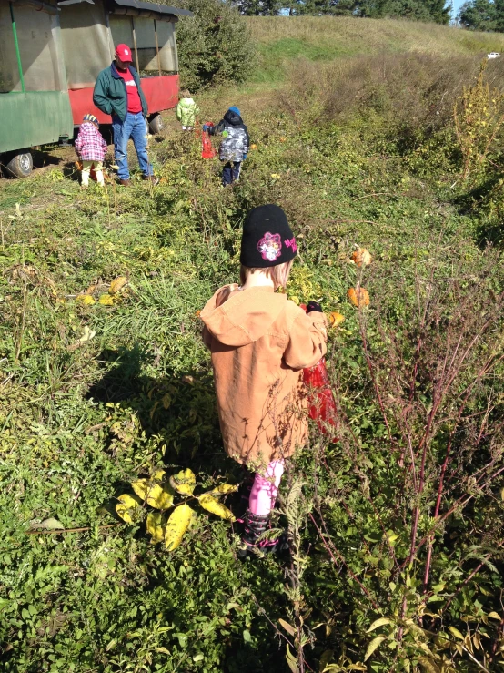 the two children are playing in a field of flowers