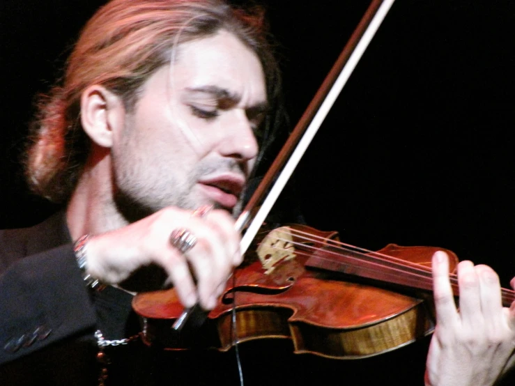 a man playing the violin on stage