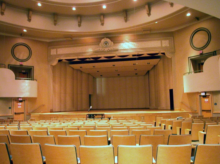 a large empty auditorium with many seats and a projector