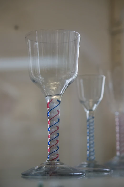 three glasses sitting on top of a counter