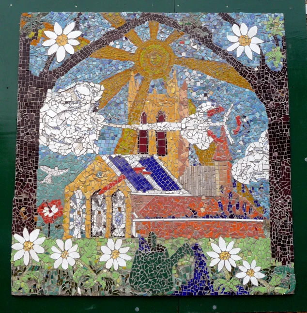 a mosaic design with flowers in front of it