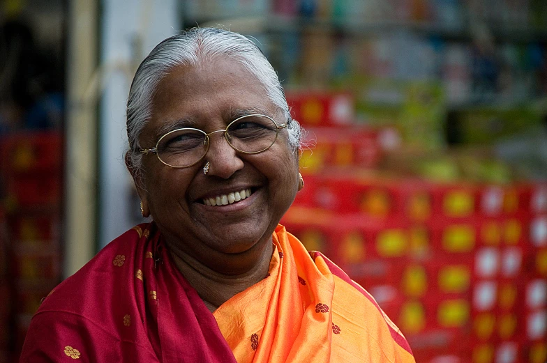 a woman in glasses and a orange dress