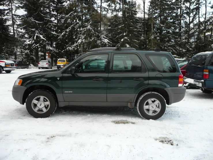 a black and gray vehicle parked in snow