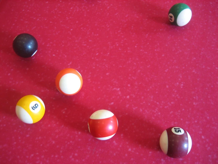 pool balls with numbers arranged on red fabric