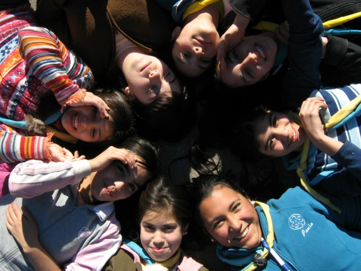 an overhead view of group of children smiling for the camera