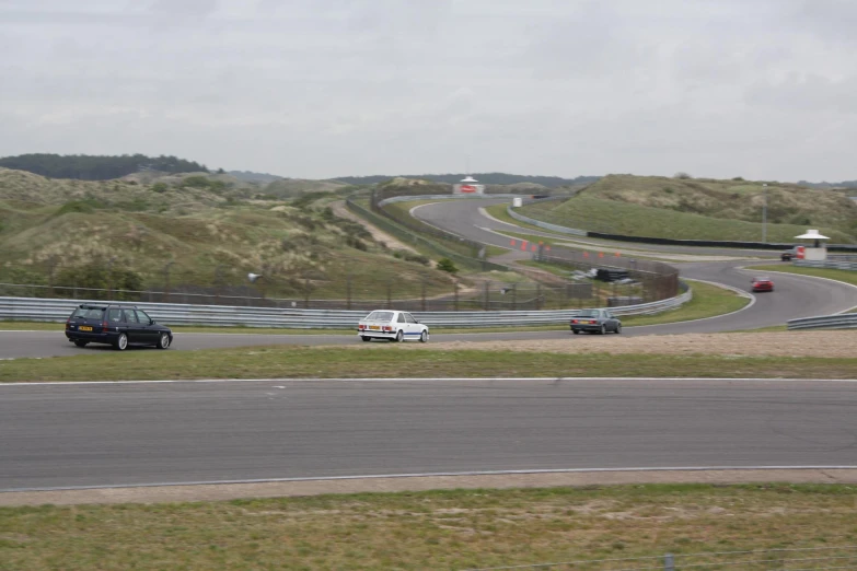 cars are driving on a curved highway through the countryside