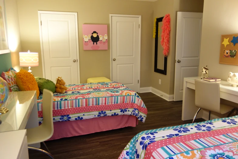 a bedroom decorated in a girl's home with brightly colored bedspreads