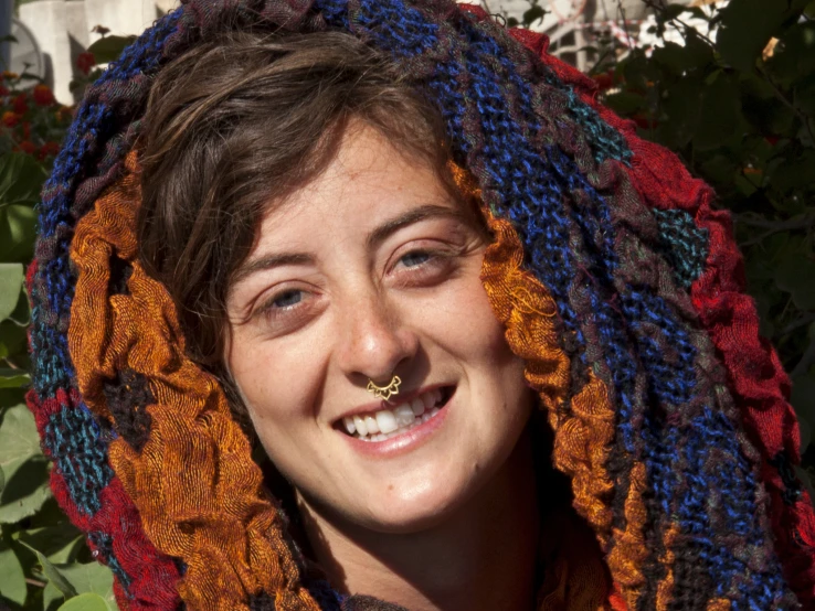 a woman is wearing an orange and blue scarf