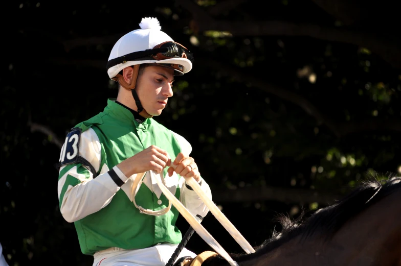 a jockey riding on the back of a horse