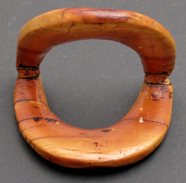a wooden circular decoration in the shape of a snake