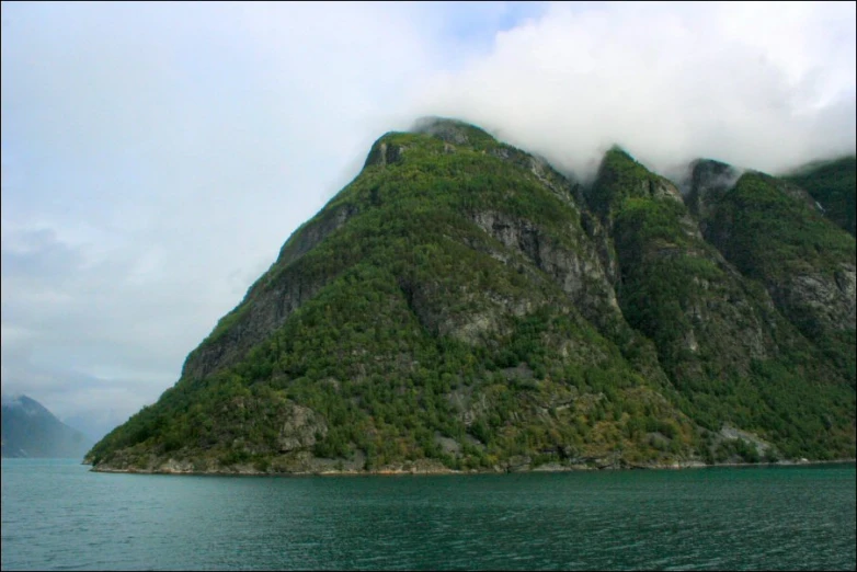 the large mountain has a lot of trees on it