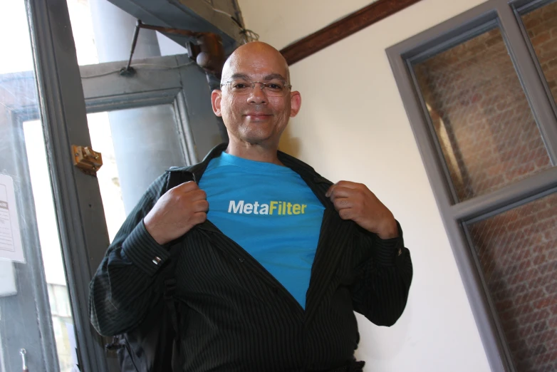 a man is displaying a t - shirt that reads metal miller