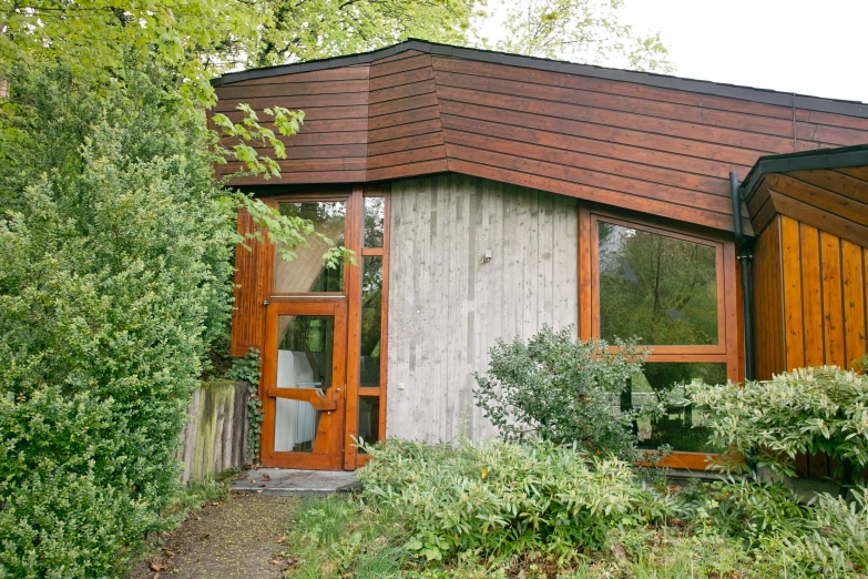 wooden exterior view of cabin and trees outside