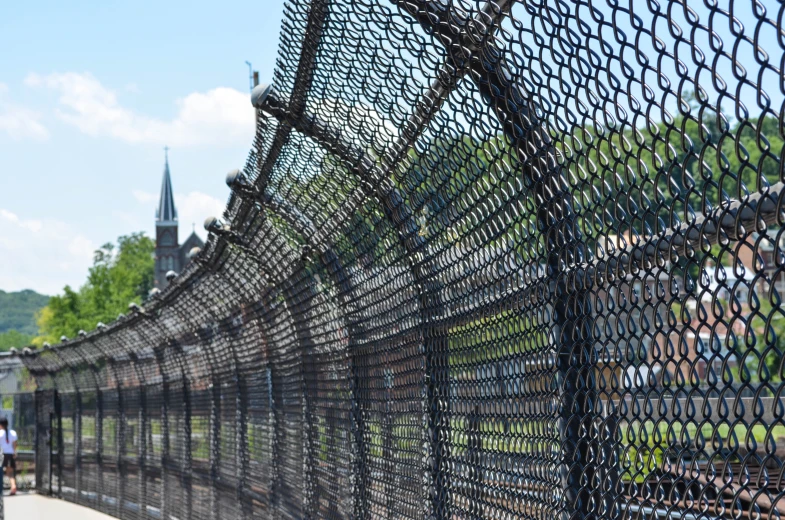 a black fence with some building in the background