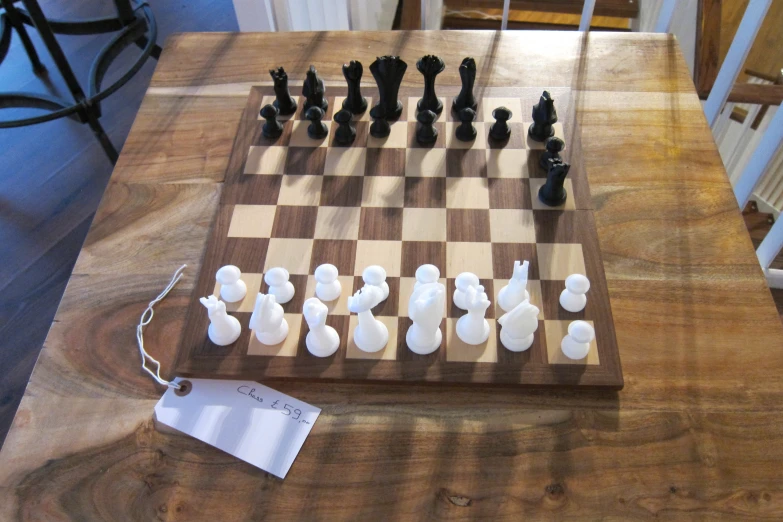 a checker board is displayed on a table with chess pieces