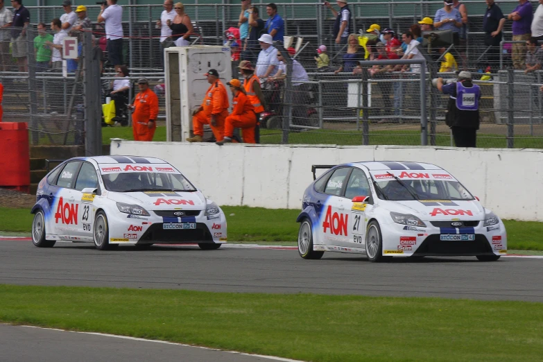 two racing cars driving on a race track