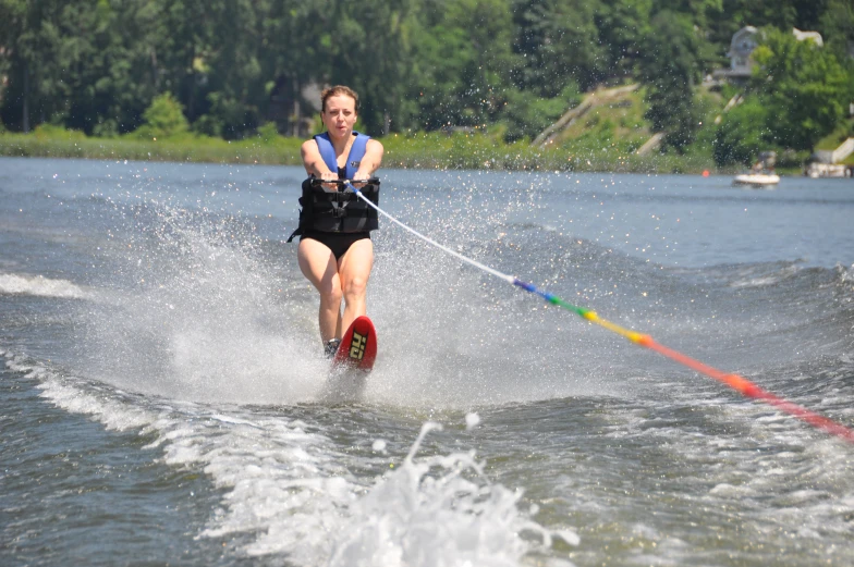 a woman is water skiing through the water