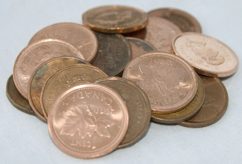 a pile of australian cents next to a knife blade