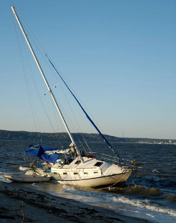 a sailboat on the beach has just made it to the shore