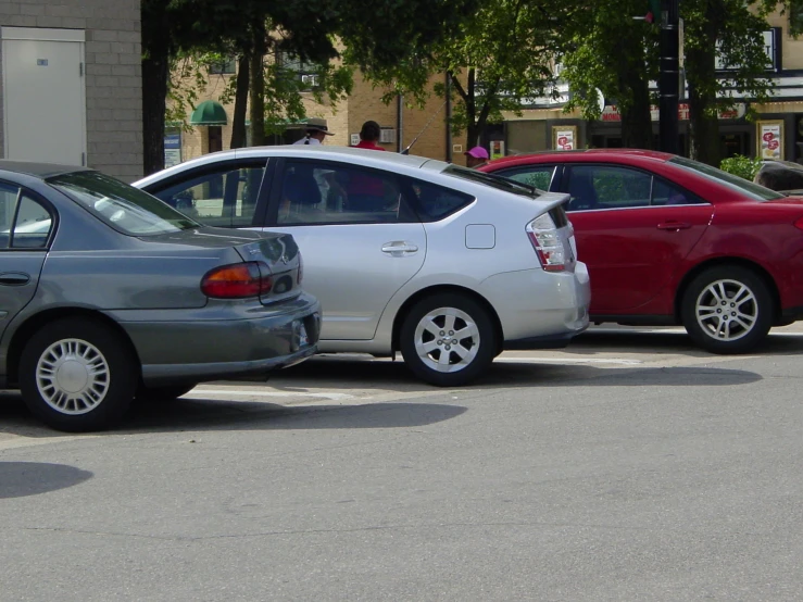 a red car is next to a silver car