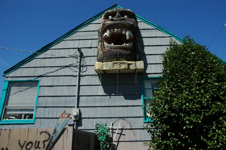 a large wooden sculpture on the outside of a house