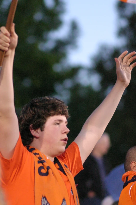 a young man holding up a ball in front of another person