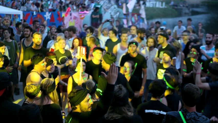 people with colored body paint in front of a crowd