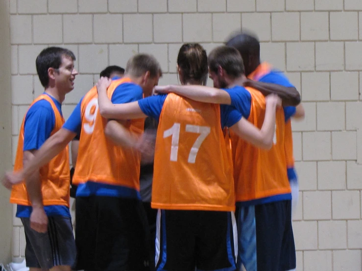 several s huddle together in front of a wall