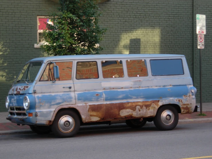 a van with a dirty roof parked on the side of the road