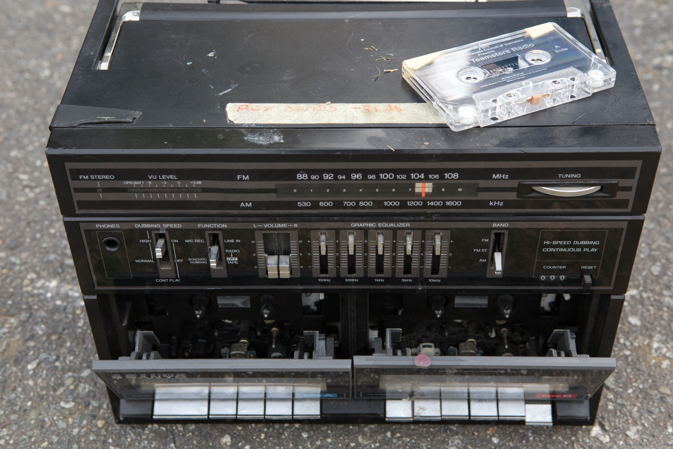 an old boombox has some small cassettes in it