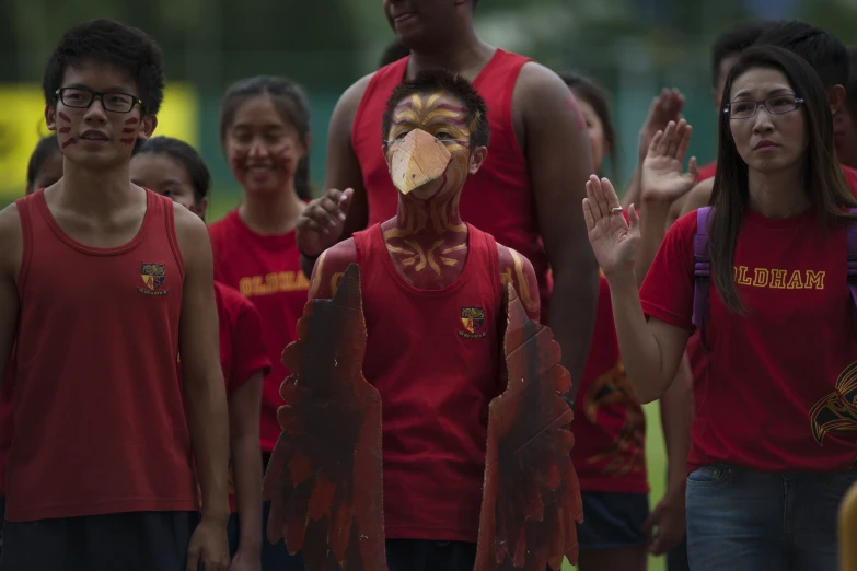 a group of children with their faces painted in native american designs