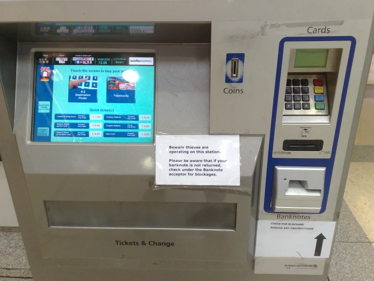 a silver pay station with ticket machines for free coins