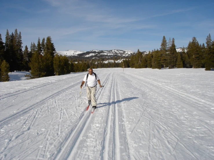 a man wearing a backpack and holding ski poles