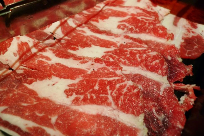 raw raw red meat in a fryer