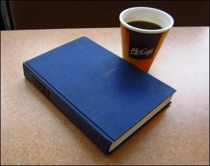 a blue book and a cup of coffee