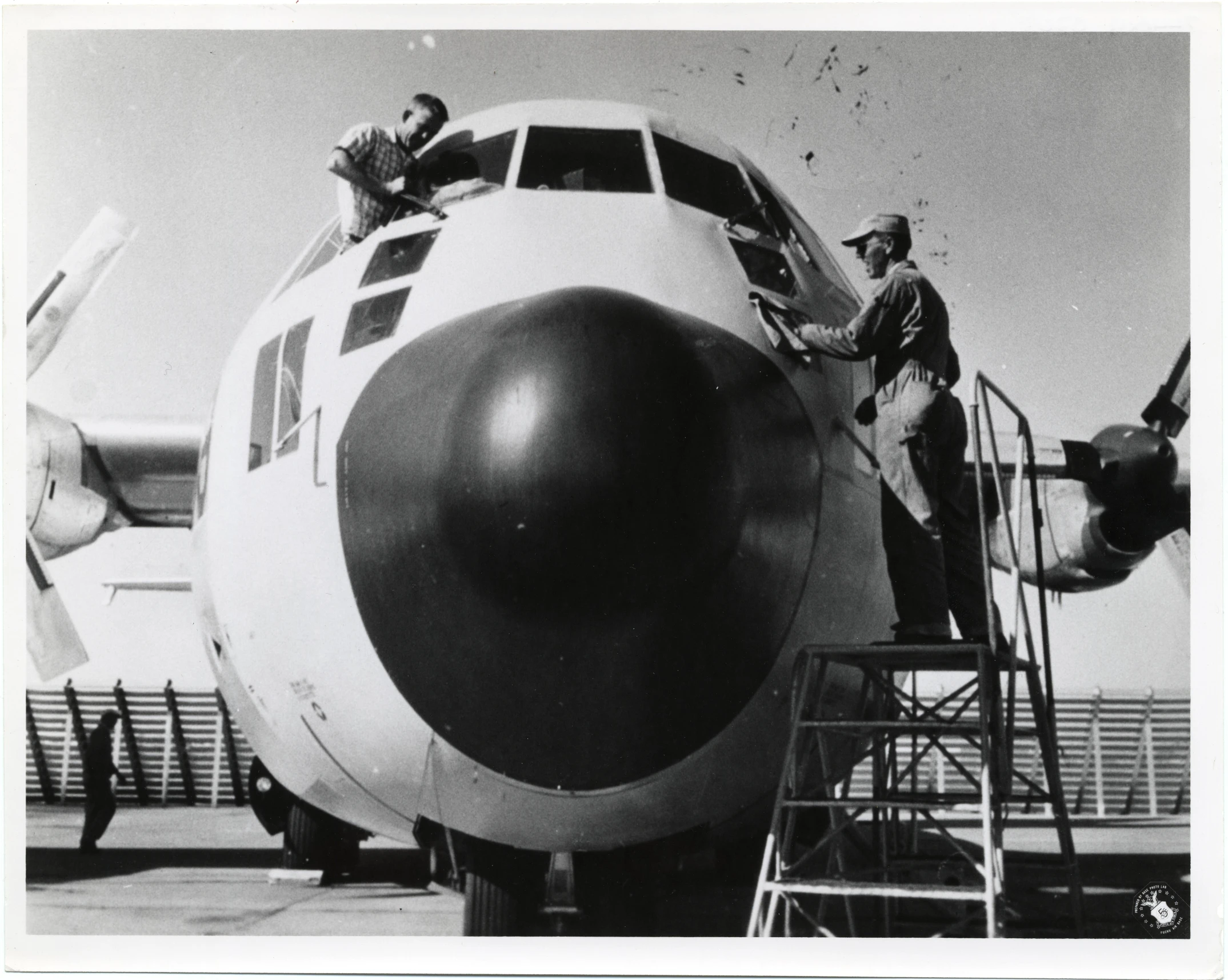 the men in uniforms are boarding a large plane