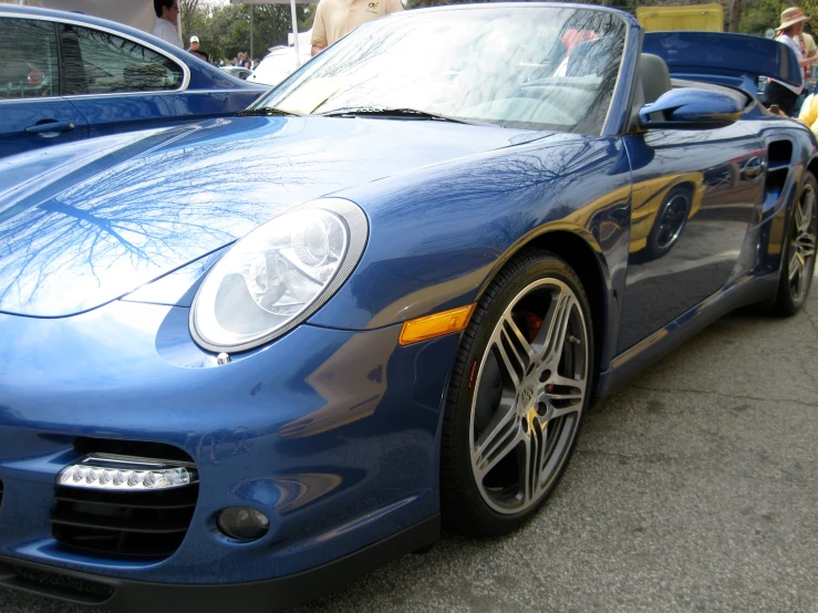 a close up of a blue car on the street