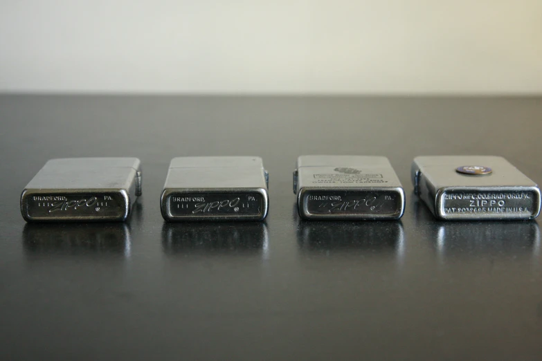 four lighters that are sitting on a table