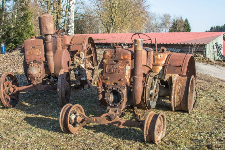 a set of rusty farm machinery sitting on top of grass