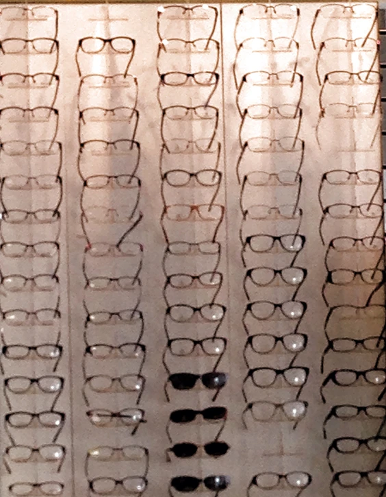 a group of glasses and a pair of sunglasses on display