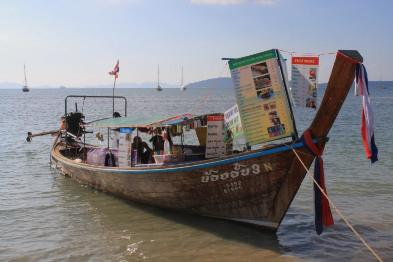 the boat is decorated with advertits and banners