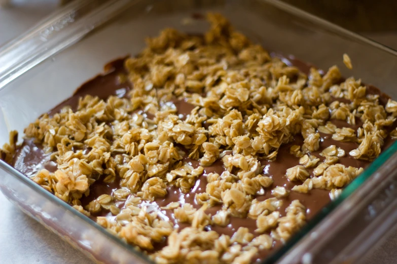 chocolate ding topped with coconut flakes in a glass casserole dish