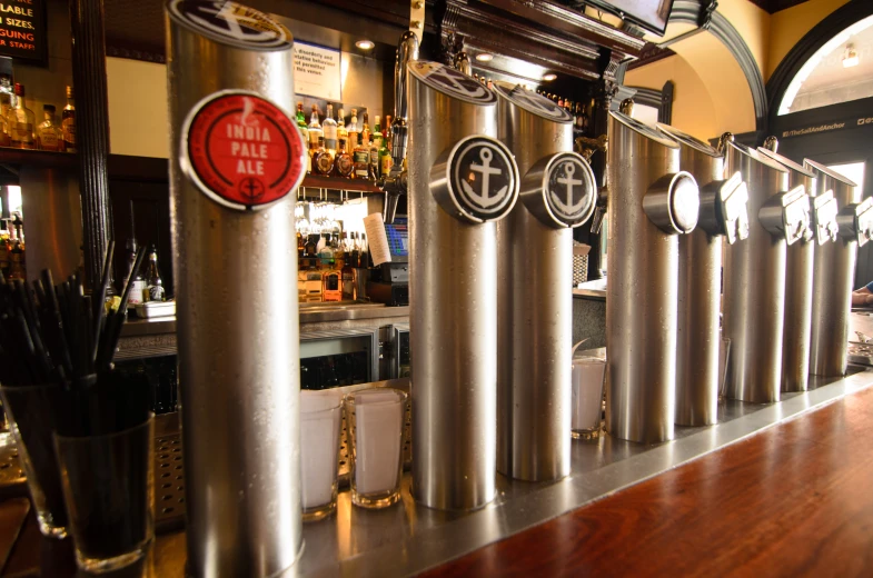 the bar has metal pipes with different types of liquor